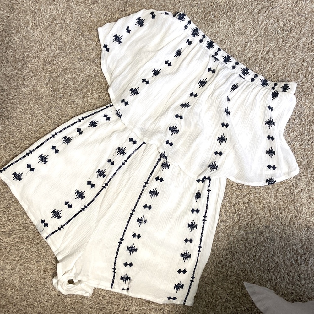 white romper with blue embroidery